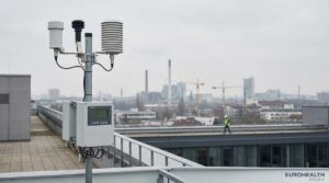 Air quality monitoring station in a European city with hazy skyline